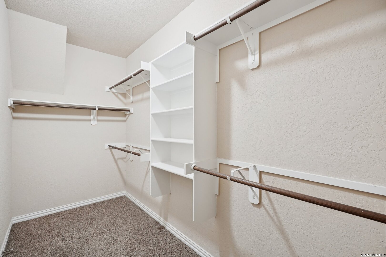 8722 Study Butte San Antonio, TX 78254 - Photo 25 of 40 a view of walk in closet with empty racks