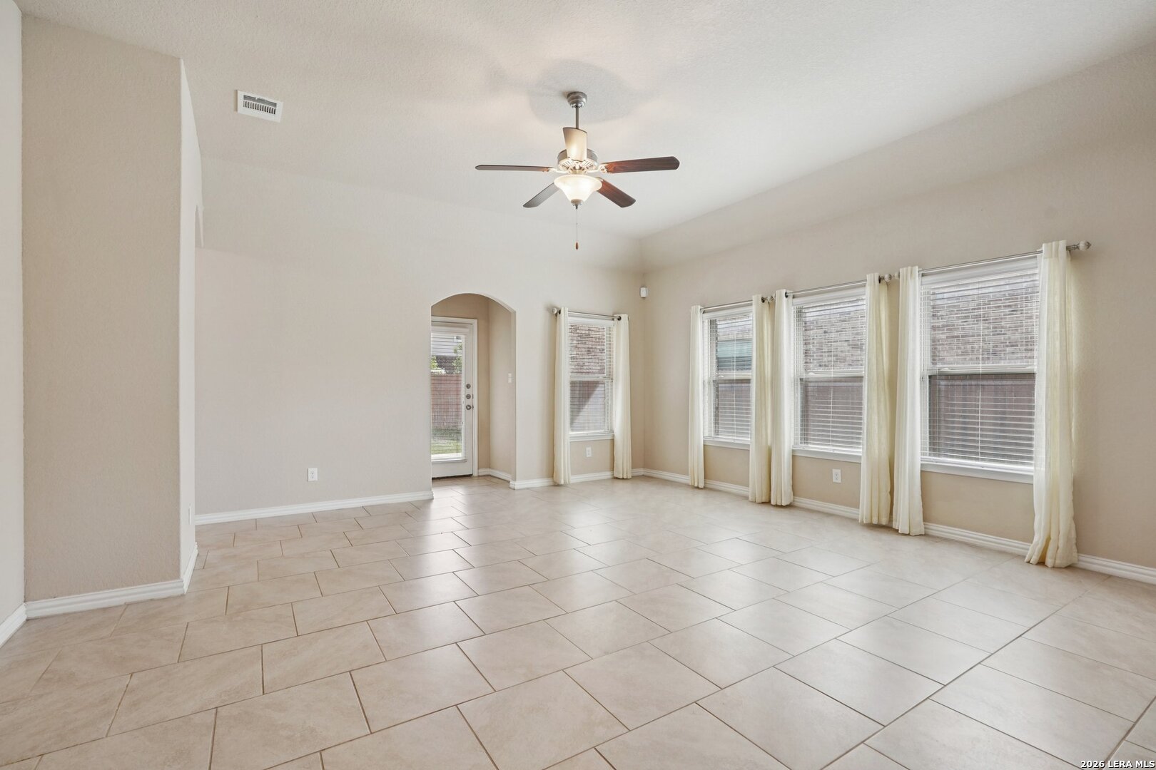 8722 Study Butte San Antonio, TX 78254 - Photo 6 of 40 a view of an empty room with a ceiling fan and window