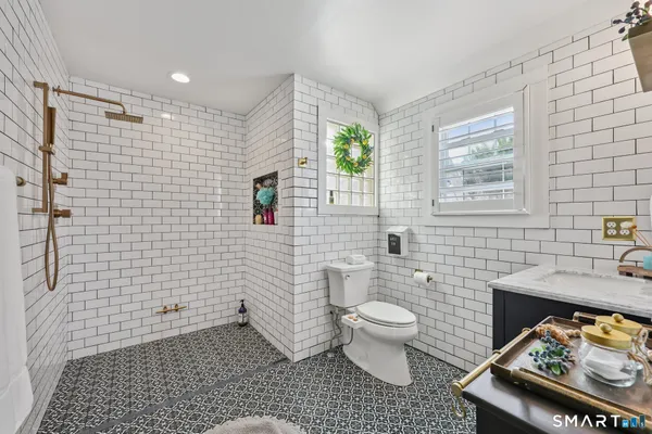 a bathroom with a toilet a sink and shower