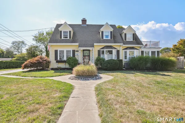a front view of house with yard and green space