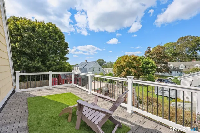 a view of a roof deck with couches and wooden floor