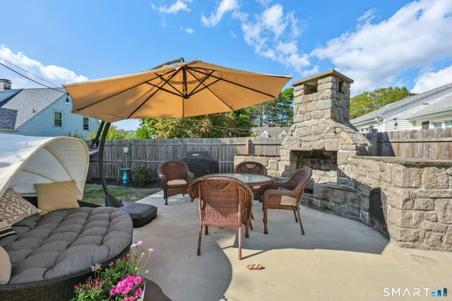 a view of an outdoor sitting area with furniture and umbrella