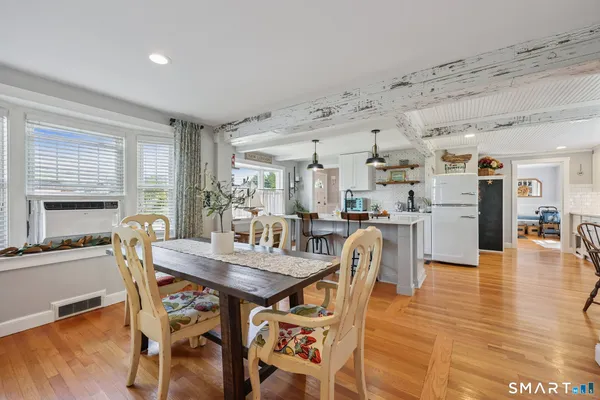 a view of a dining room with furniture and wooden floor