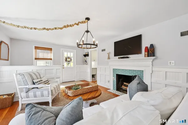 a living room with furniture a flat screen tv and a fireplace