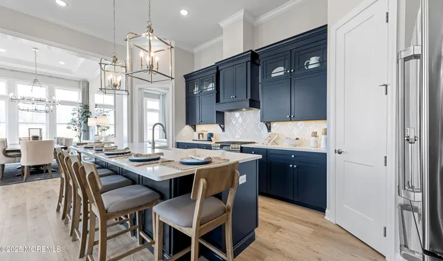 a kitchen with granite countertop a sink cabinets and wooden floor