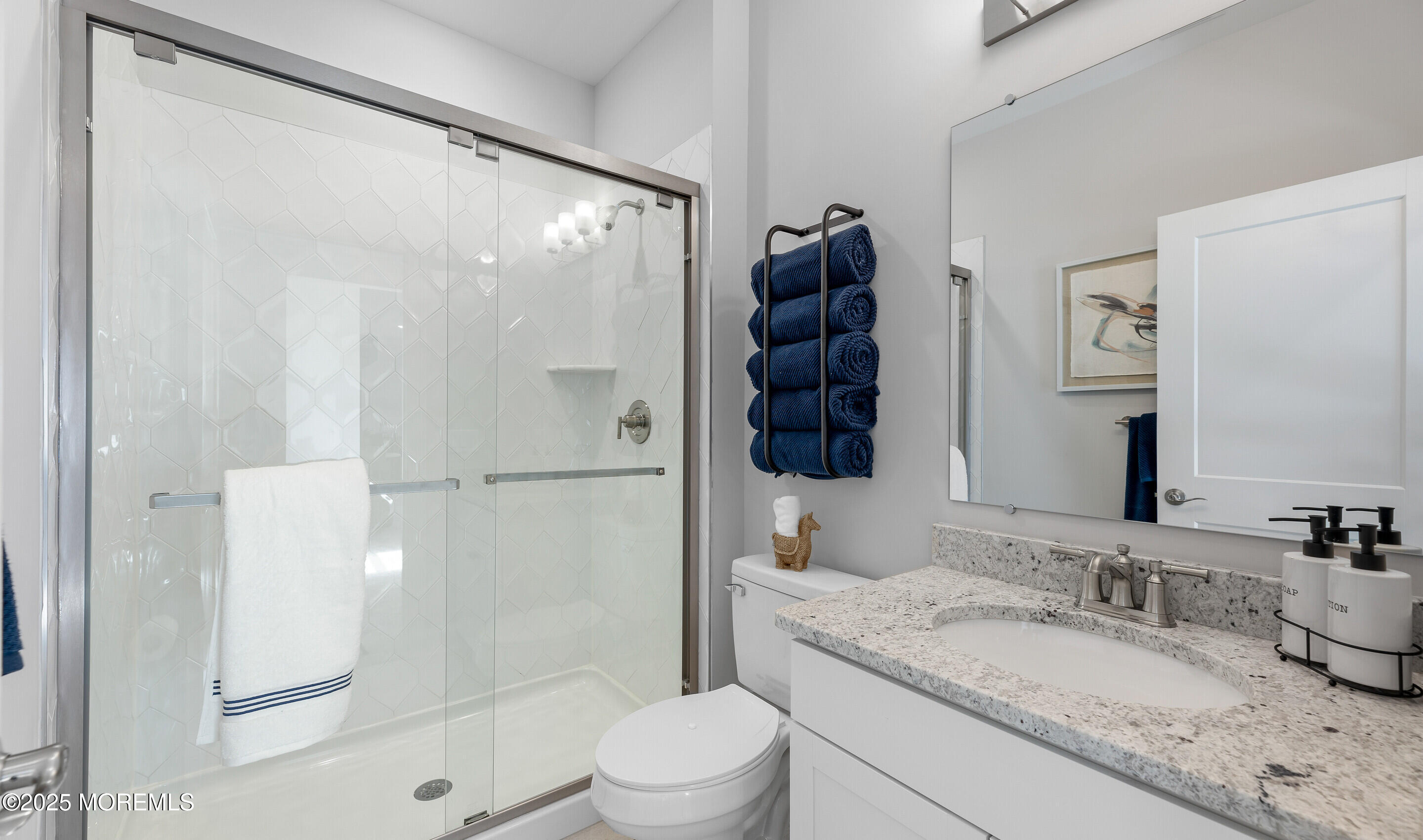 176 Highway 33, Unit KILLARNEY III LOFT Manalapan, NJ 07726 - Photo 26 of 41 a bathroom with a granite countertop sink mirror vanity and toilet
