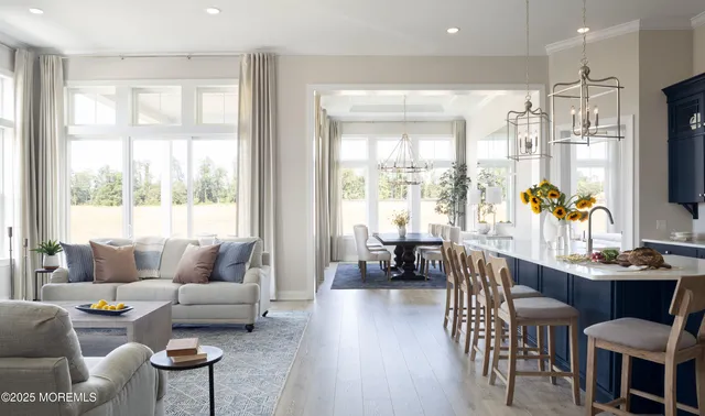 a living room with furniture a flat screen tv and a large window