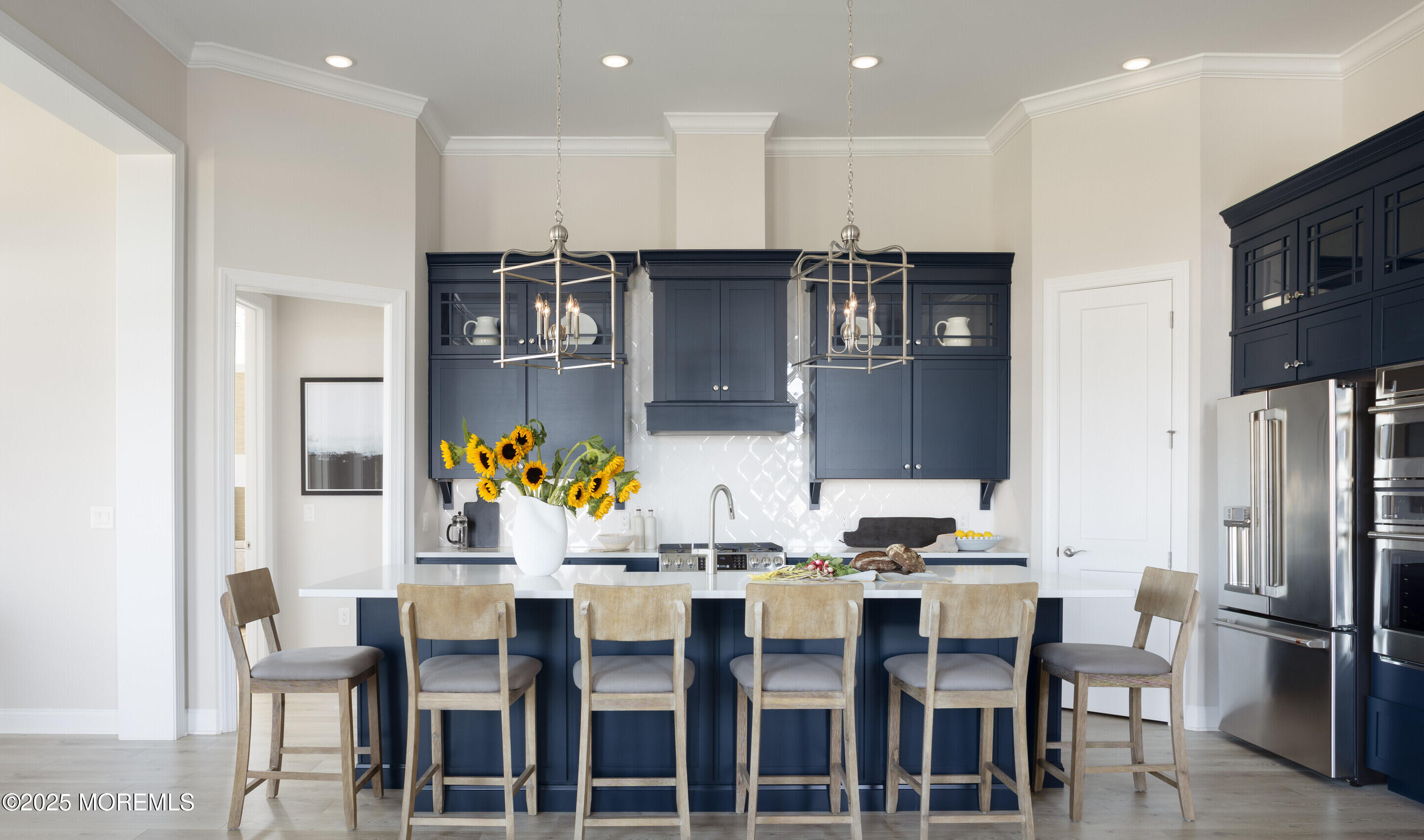 176 Highway 33, Unit KILLARNEY III LOFT Manalapan, NJ 07726 - Photo 33 of 41 a kitchen with stainless steel appliances kitchen island granite countertop a dining table chairs and refrigerator
