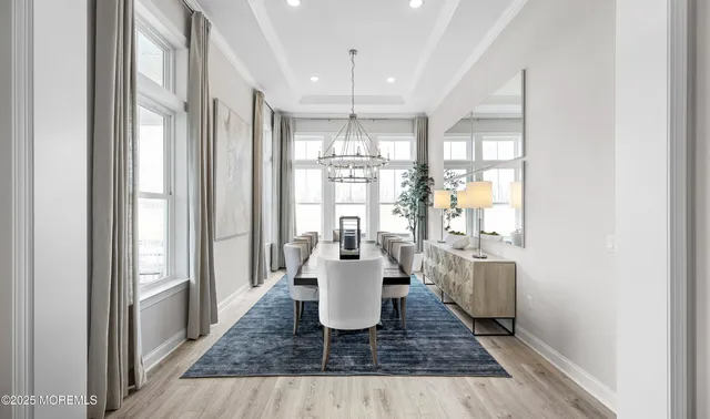 a dining room with wooden floor and window