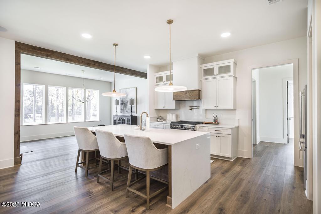 1731 Blue Springs Road Buckhead, GA 30625 - Photo 29 of 50 a kitchen with a dining table chairs refrigerator and wooden floor