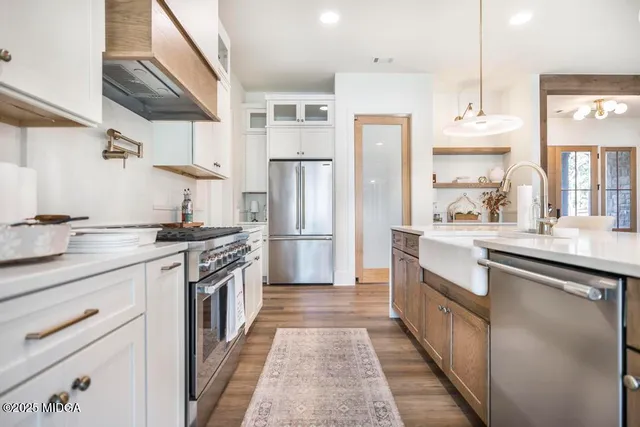 a kitchen with stainless steel appliances a sink stove and refrigerator