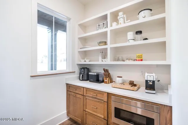 a kitchen with cabinets and window