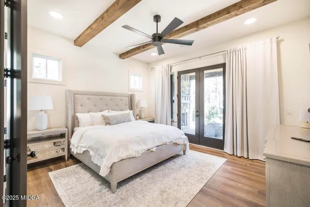 a bedroom with a large bed and a chandelier