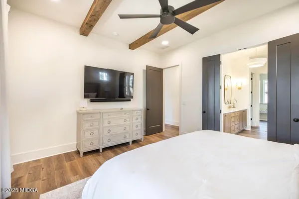 a bedroom with a bed and a flat screen tv
