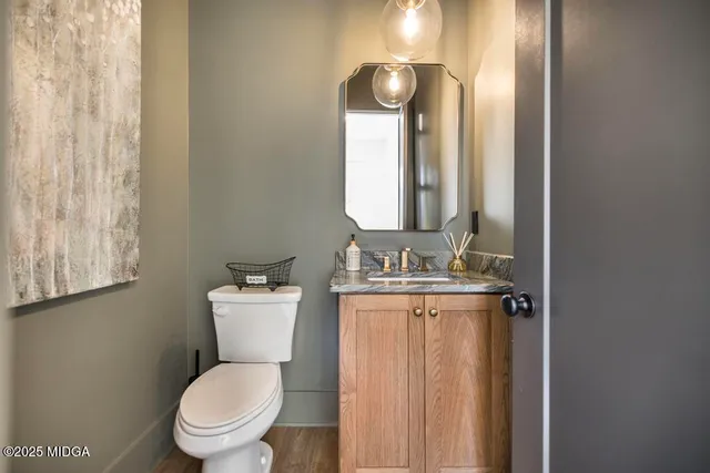 a bathroom with a toilet a sink and mirror