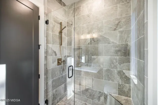 a bathroom with a glass shower door