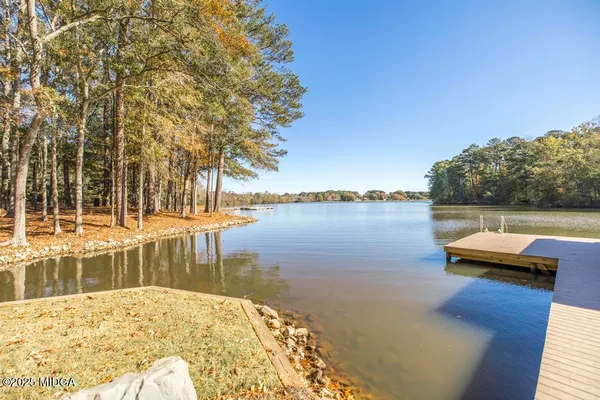 swimming pool view with a lake view