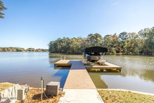 a view of a lake with chairs