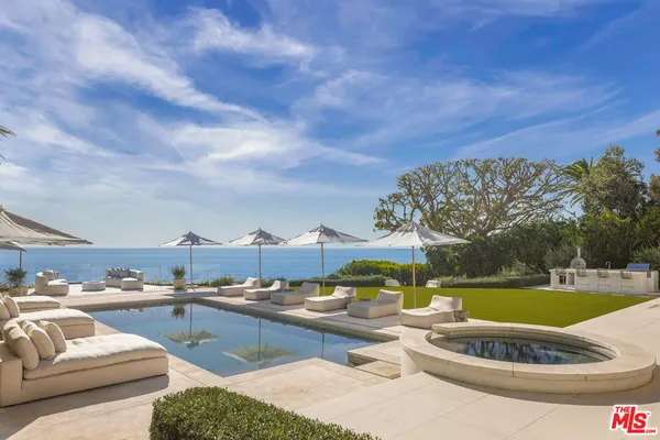 a view of swimming pool with outdoor seating and city view