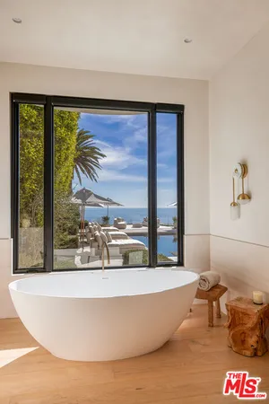 a bathroom with a tub and shower