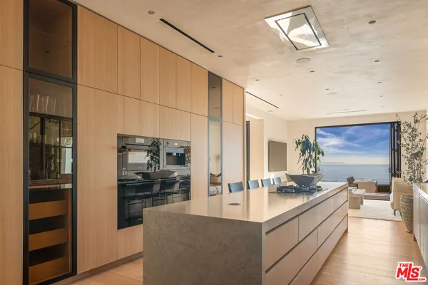 a kitchen with granite countertop a table and chairs