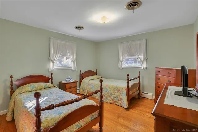 a bedroom with furniture and a wooden floor