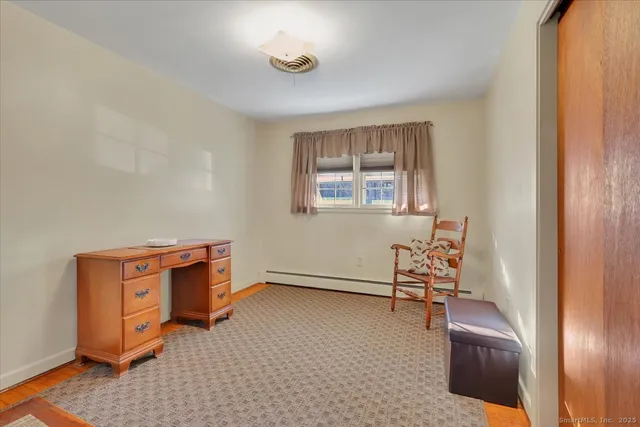 an empty room with furniture and windows