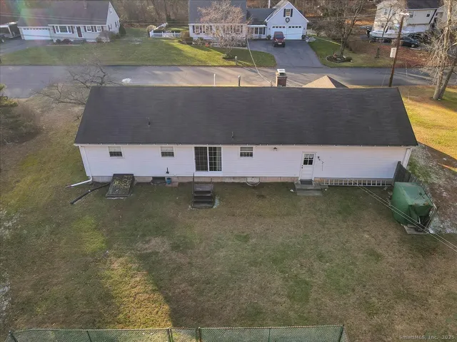 an aerial view of a house with a yard