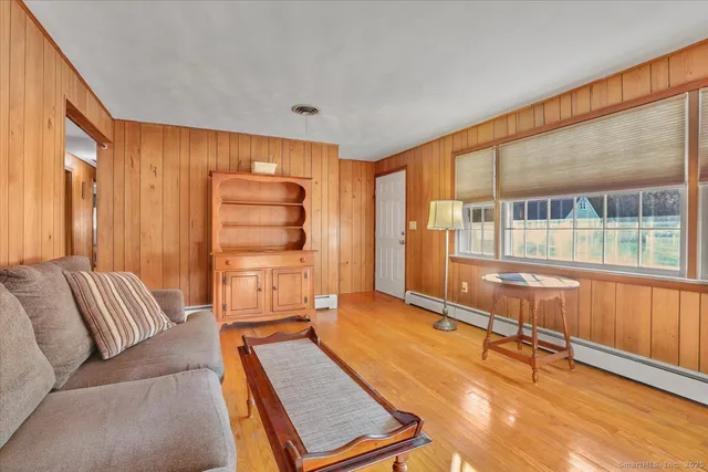 a living room with a couch and next to a window