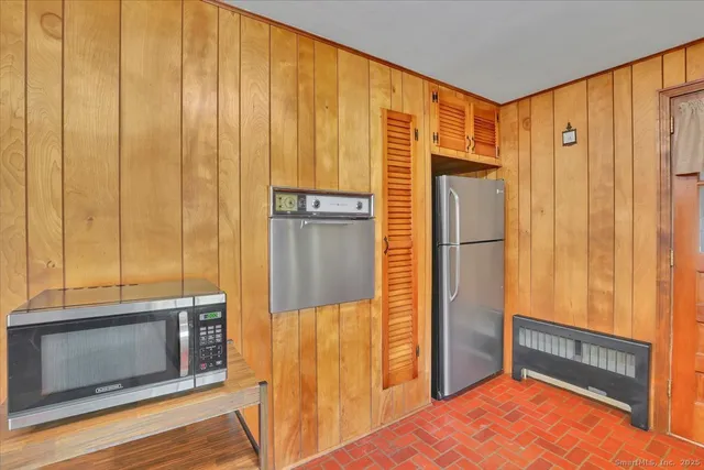 a kitchen with stainless steel appliances granite countertop a refrigerator and a stove top oven