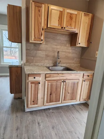 a kitchen with granite countertop a sink and a stove