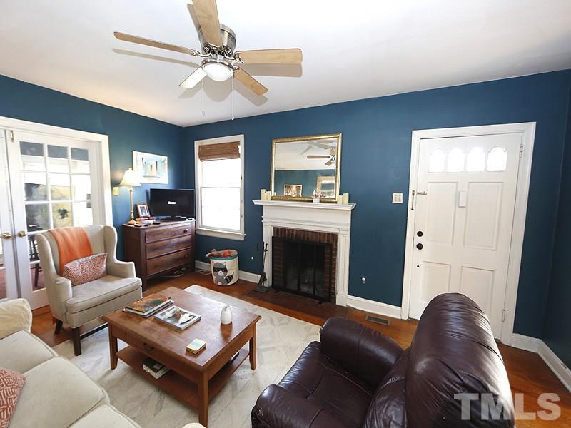 2613 Van Dyke Avenue Raleigh, NC 27607 - Photo 2 of 24 a living room with furniture a fireplace and a chandelier