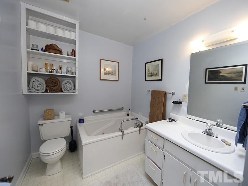 2613 Van Dyke Avenue Raleigh, NC 27607 - Photo 13 of 24 a bathroom with a toilet sink and mirror