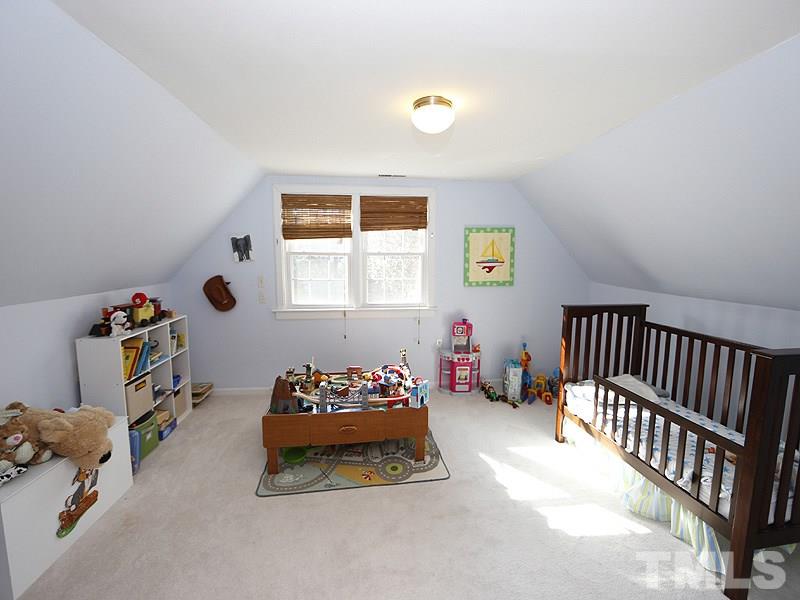 2613 Van Dyke Avenue Raleigh, NC 27607 - Photo 18 of 24 a bedroom with a bed and a window