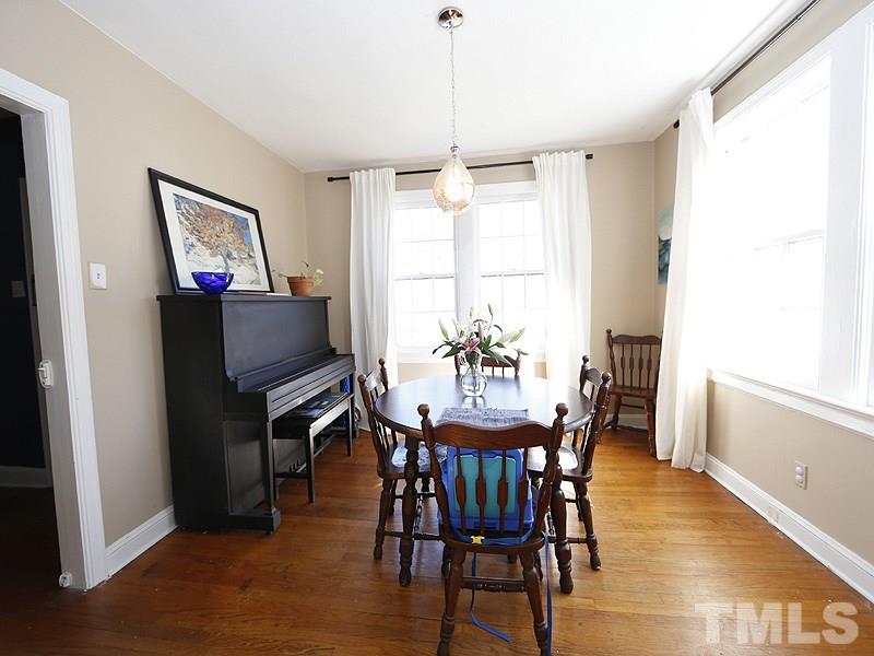 2613 Van Dyke Avenue Raleigh, NC 27607 - Photo 6 of 24 a dining room with furniture a window and wooden floor