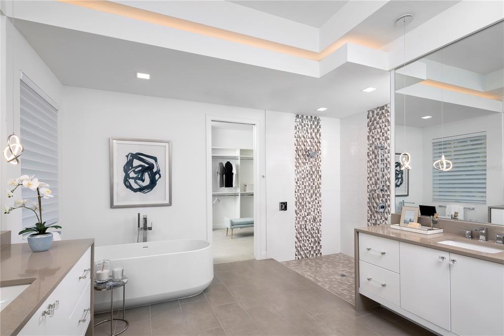 12364 Southwest 16th Lane Gainesville, FL 32607 - Photo 11 of 20 a spacious bathroom with double vanity a mirror a lamp and bathtub