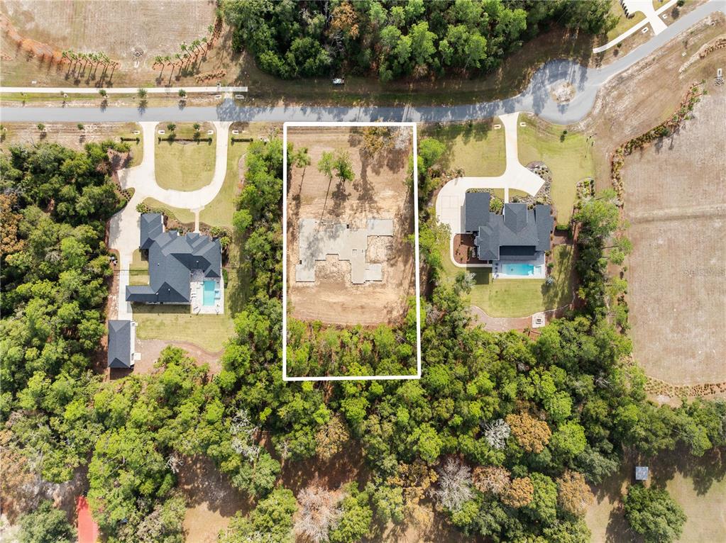 12364 Southwest 16th Lane Gainesville, FL 32607 - Photo 19 of 20 an aerial view of a house with a garden and lake view