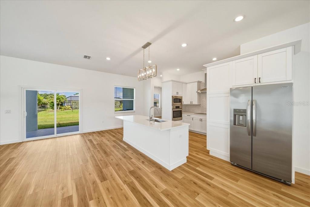 1215 Rio De Janeiro Avenue Punta Gorda, FL 33983 - Photo 24 of 65 a view of kitchen with stainless steel appliances refrigerator stove and cabinets