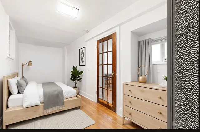 a dining room with wooden floor a chandelier a wooden table and chairs