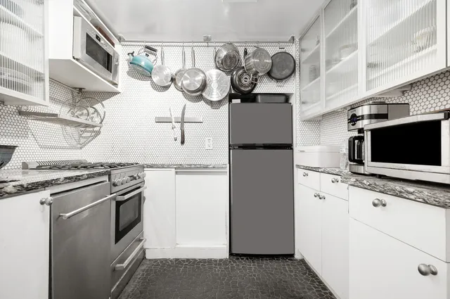 a kitchen with a sink appliances and cabinets