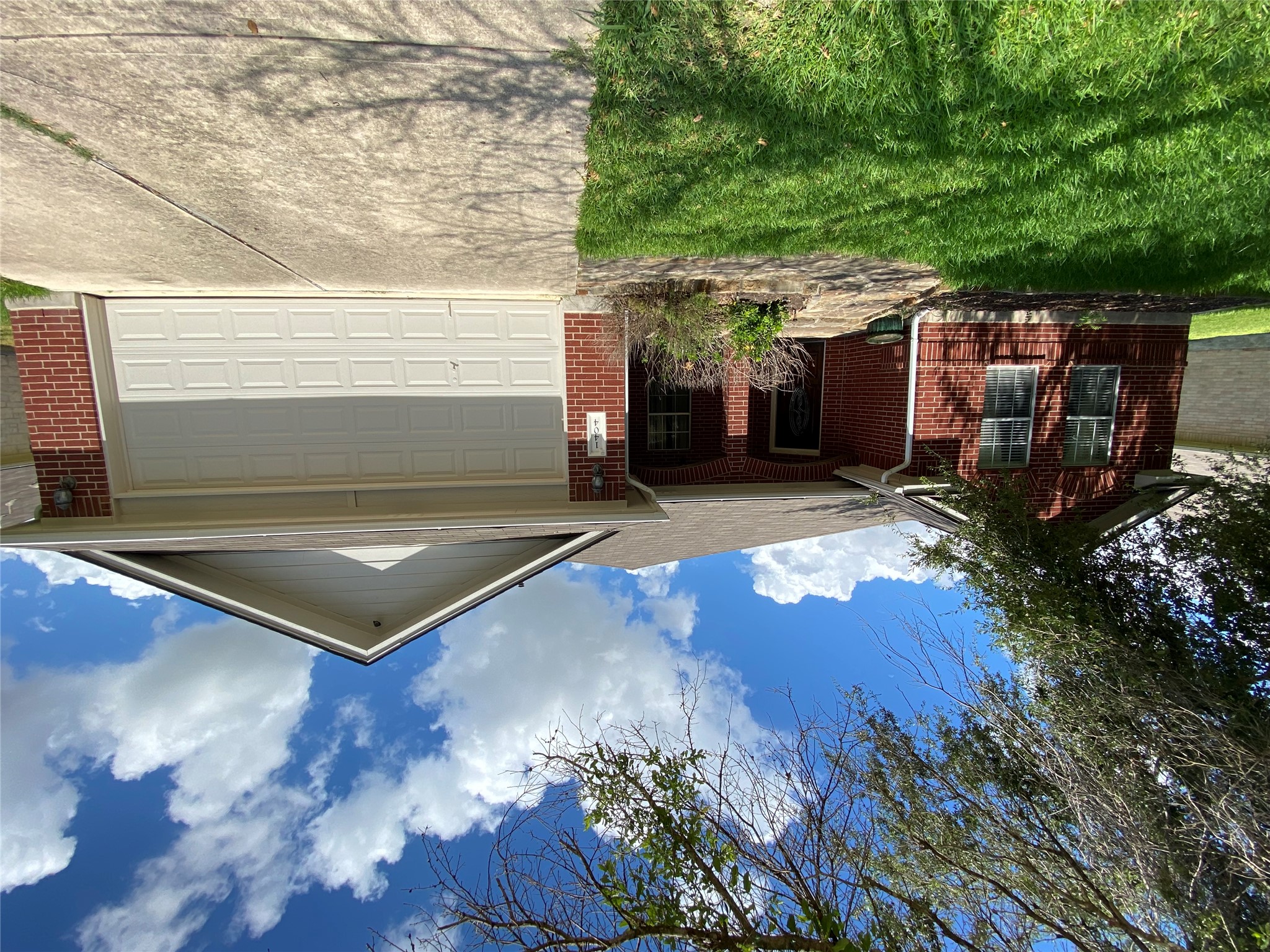 1404 Terra Street Round Rock, TX 78665 - Photo 1 of 15 Ranch-style house with brick siding, concrete driveway, a porch, a front lawn, and a garage