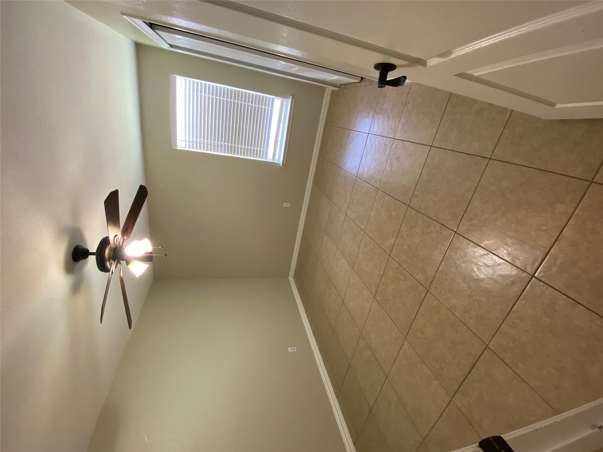 1404 Terra Street Round Rock, TX 78665 - Photo 11 of 15 Unfurnished room with ceiling fan and light tile patterned flooring