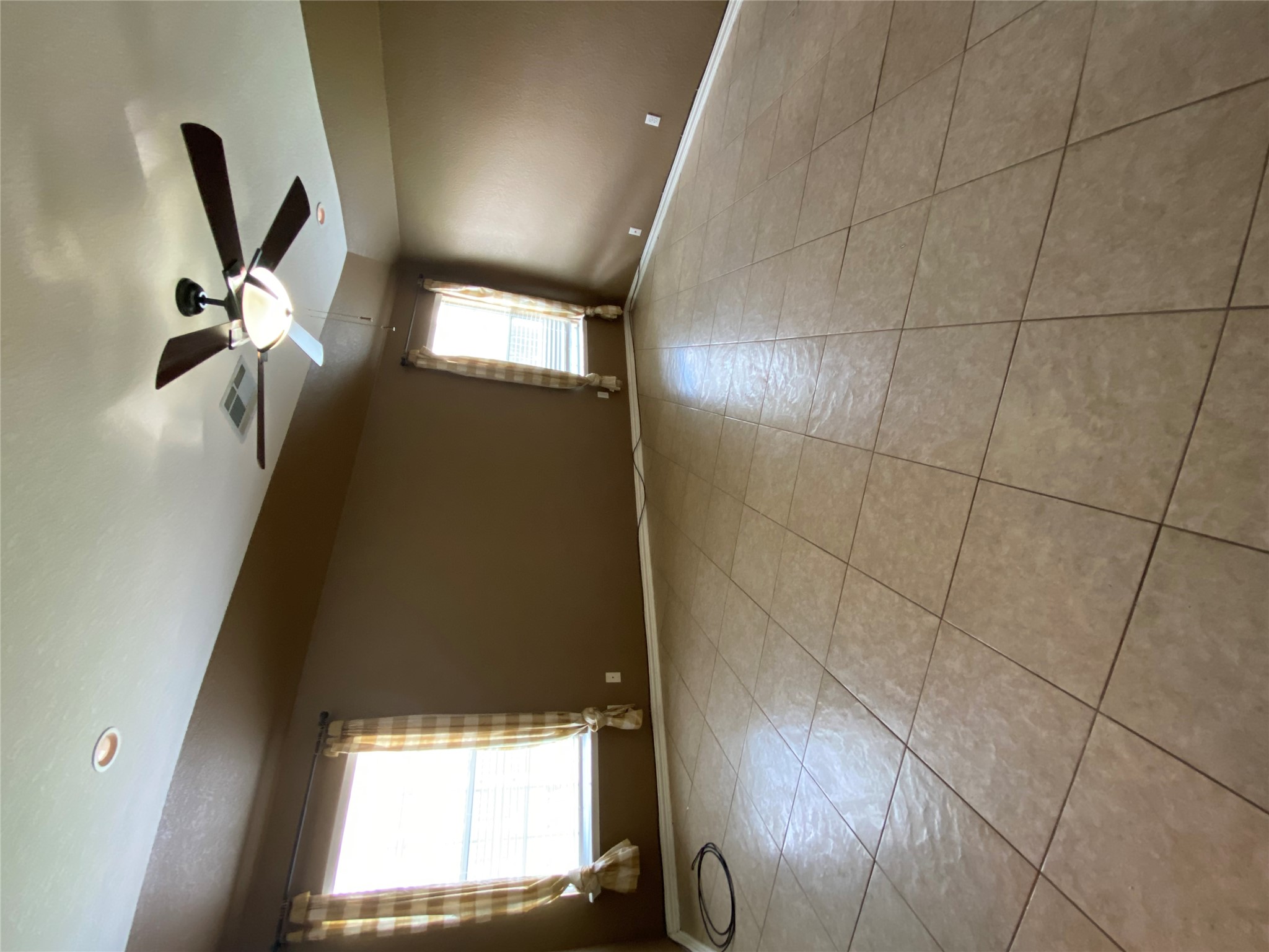 1404 Terra Street Round Rock, TX 78665 - Photo 12 of 15 Empty room featuring ceiling fan and light tile patterned floors