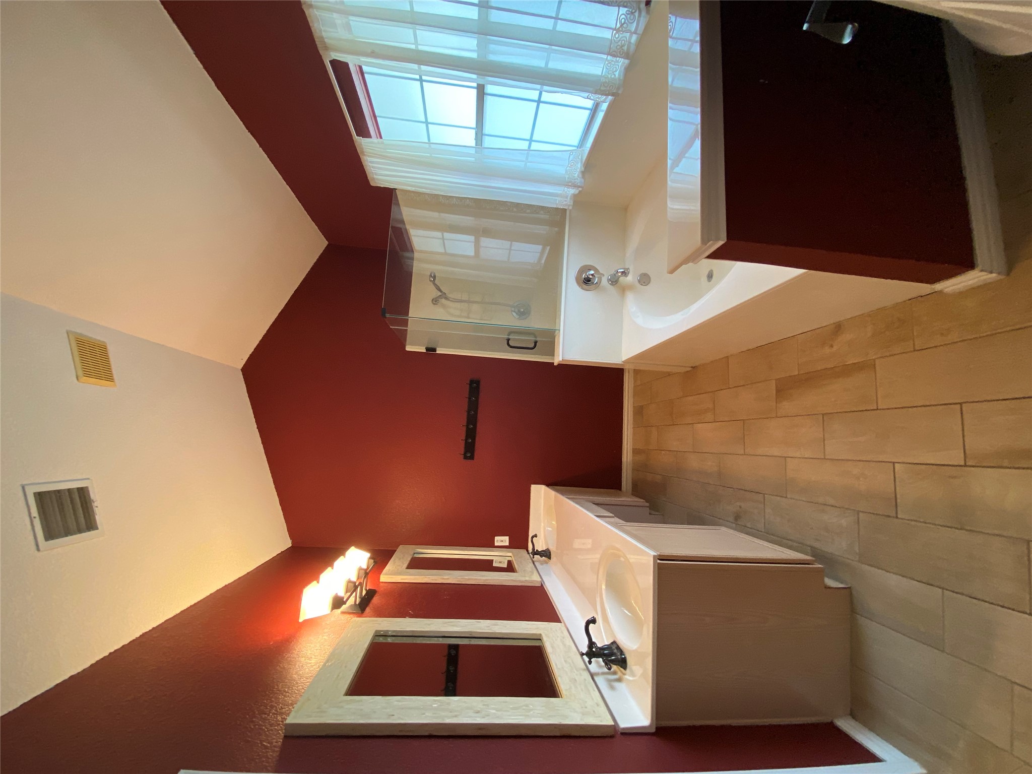 1404 Terra Street Round Rock, TX 78665 - Photo 13 of 15 Bathroom with a bath, vaulted ceiling, a stall shower, double vanity, and wood finish floors