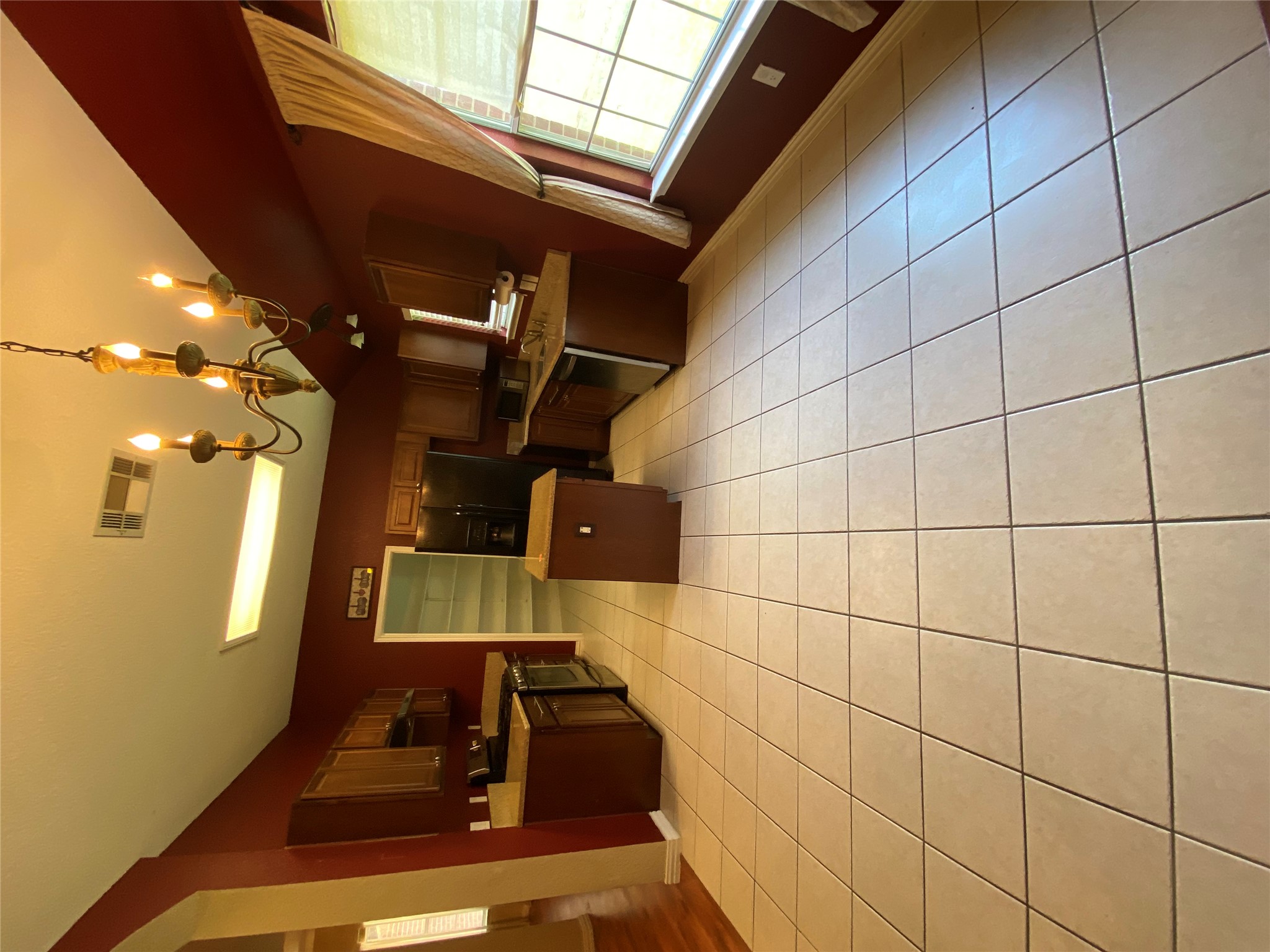 1404 Terra Street Round Rock, TX 78665 - Photo 3 of 15 Kitchen with a chandelier, a center island, decorative light fixtures, appliances with stainless steel finishes, and light countertops