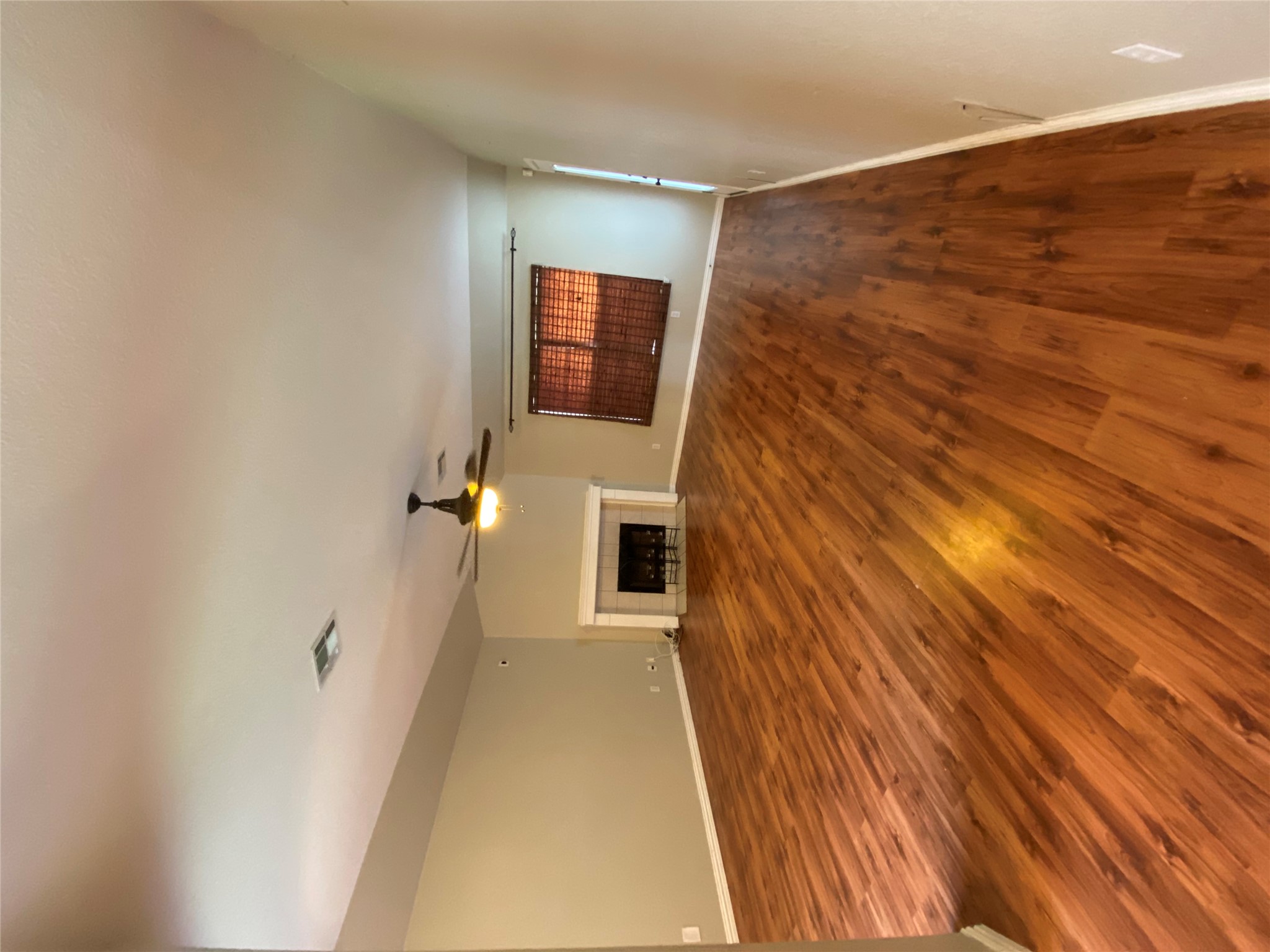 1404 Terra Street Round Rock, TX 78665 - Photo 4 of 15 Unfurnished living room with a tile fireplace, dark wood finished floors, and a ceiling fan