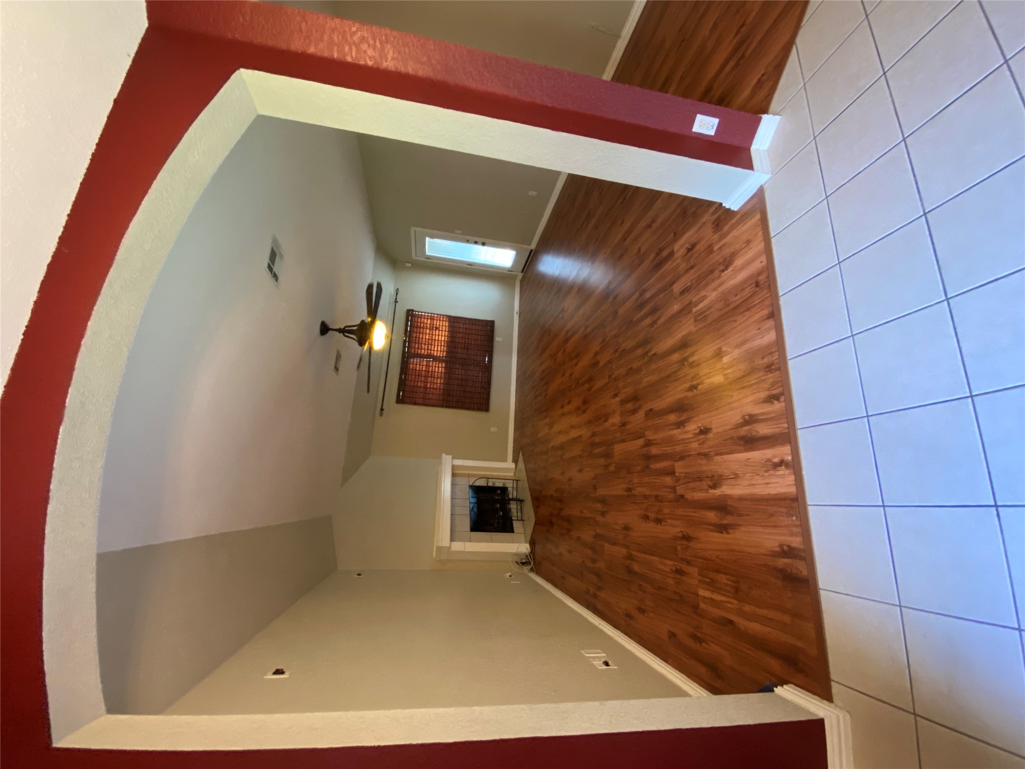1404 Terra Street Round Rock, TX 78665 - Photo 5 of 15 Unfurnished living room featuring light tile patterned floors, arched walkways, ceiling fan, and a tiled fireplace