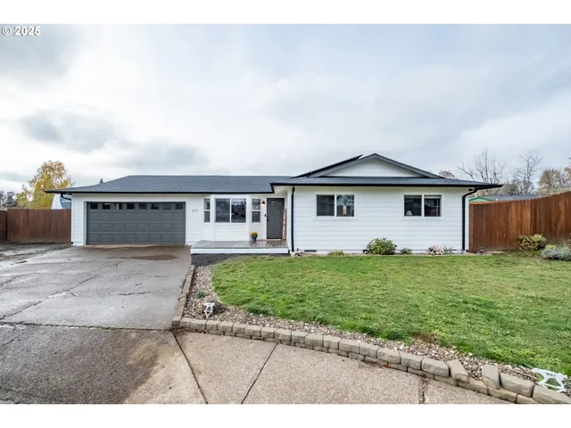 a front view of a house with a garden