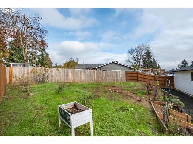 a view of a house with a yard and sitting area