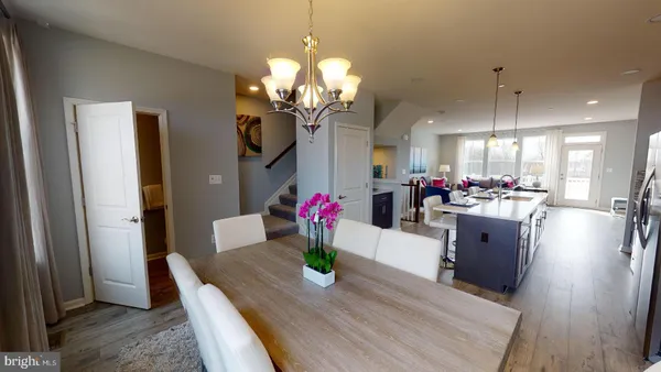 a view of a dining room with furniture wooden floor and chandelier